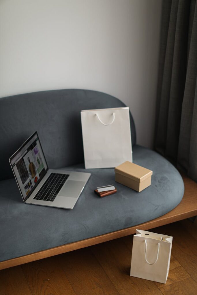 Contemporary e-commerce scene with laptop, shopping bags, and a credit card, ideal for online shopping concepts.